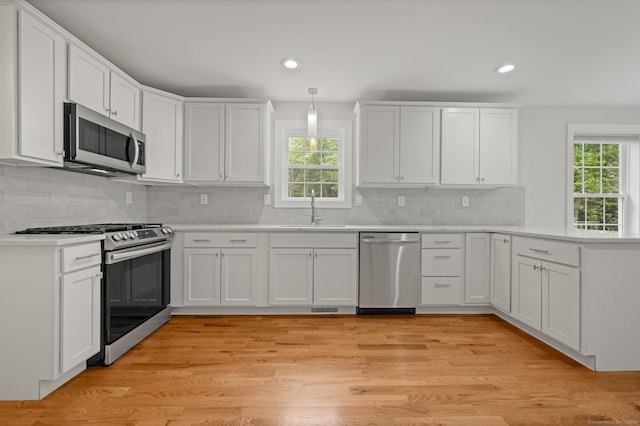 54 Edgerton Rd, Granby, CT 06090 - kitchen with appliances with stainless steel finishes, healthy amount of natural light, a peninsula, light countertops, and recessed lighting