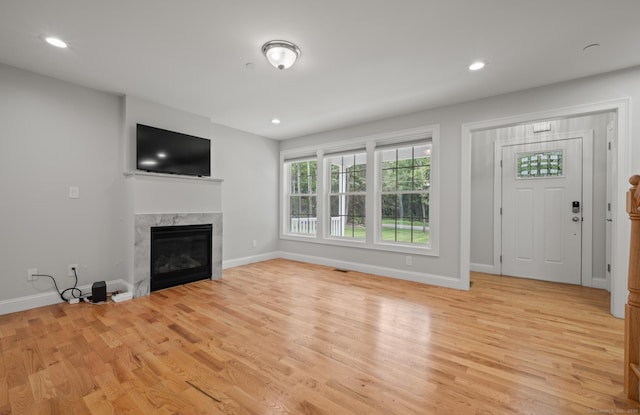 54 Edgerton Rd, Granby, CT 06090 - unfurnished living room with light wood finished floors, a premium fireplace, and recessed lighting