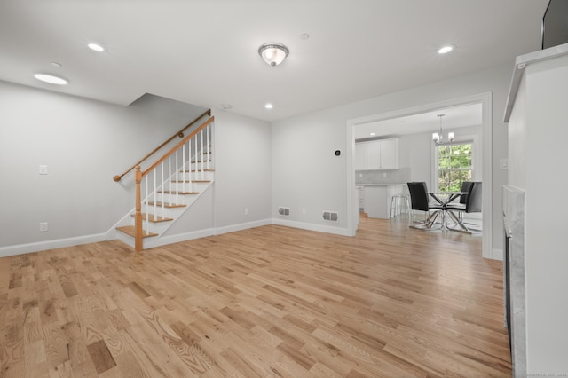 54 Edgerton Rd, Granby, CT 06090 - unfurnished living room featuring light wood-style flooring, stairs, a chandelier, and recessed lighting