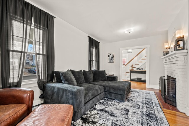 16 Academy St, Manchester, CT 06040 - living area featuring a fireplace, wood finished floors, baseboards, and stairs