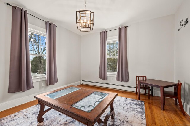 16 Academy St, Manchester, CT 06040 - sitting room with wood finished floors, a chandelier, and a healthy amount of sunlight