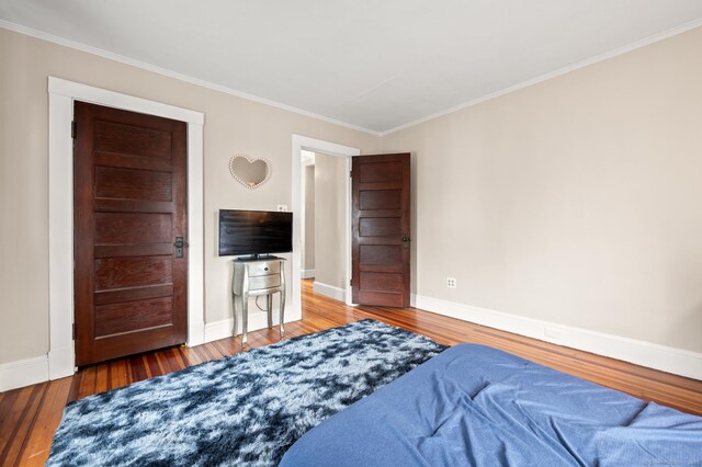 16 Academy St, Manchester, CT 06040 - bedroom with baseboards, wood finished floors, and crown molding