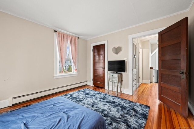 16 Academy St, Manchester, CT 06040 - bedroom with a baseboard heating unit, baseboards, ornamental molding, and light wood finished floors