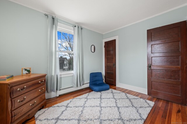 16 Academy St, Manchester, CT 06040 - sitting room with a baseboard heating unit, wood finished floors, baseboards, and ornamental molding