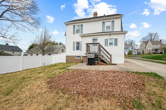 16 Academy St, Manchester, CT 06040 - rear view of property featuring a chimney, fence, a residential view, and a lawn