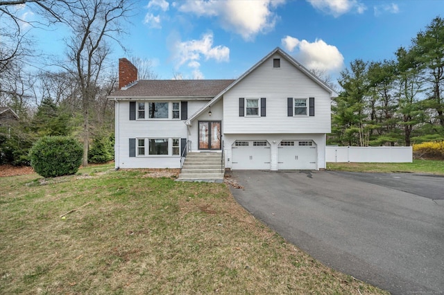 394 Woodhaven Rd, Glastonbury, CT 06033 - bi-level home featuring driveway, a chimney, a front lawn, and a garage