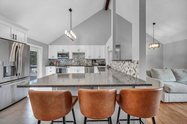 394 Woodhaven Rd, Glastonbury, CT 06033 - kitchen with a chandelier, backsplash, stainless steel appliances, and a peninsula