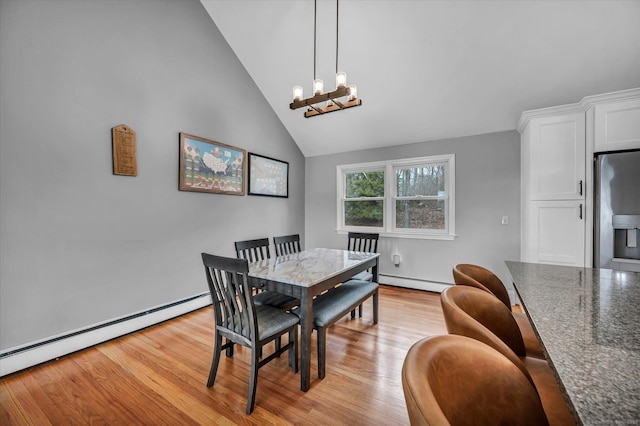 394 Woodhaven Rd, Glastonbury, CT 06033 - dining space with a baseboard radiator, light wood-style flooring, lofted ceiling, and a notable chandelier