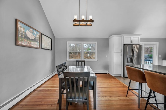 394 Woodhaven Rd, Glastonbury, CT 06033 - dining space with a baseboard heating unit, vaulted ceiling, wood finished floors, and a chandelier