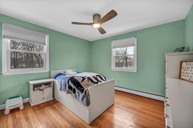 394 Woodhaven Rd, Glastonbury, CT 06033 - bedroom with baseboards, a ceiling fan, wood finished floors, and a baseboard radiator