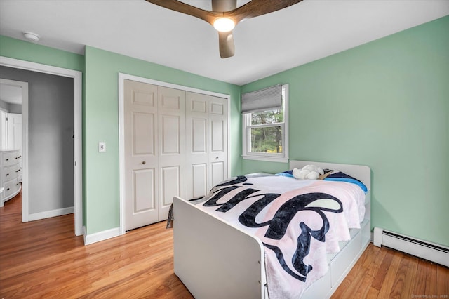 394 Woodhaven Rd, Glastonbury, CT 06033 - bedroom with a baseboard radiator, a ceiling fan, a closet, light wood-style flooring, and baseboards