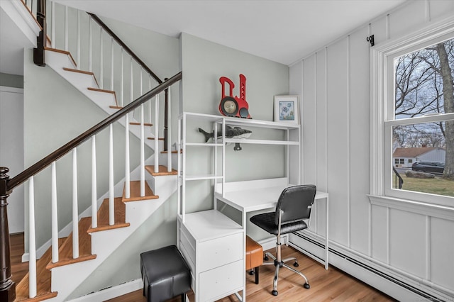 394 Woodhaven Rd, Glastonbury, CT 06033 - home office featuring wood finished floors, a baseboard radiator, and a decorative wall
