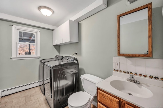 394 Woodhaven Rd, Glastonbury, CT 06033 - bathroom with washer and clothes dryer, tasteful backsplash, toilet, baseboard heating, and vanity