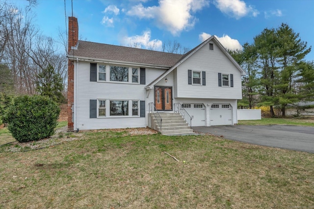 394 Woodhaven Rd, Glastonbury, CT 06033 - split foyer home with a chimney, aphalt driveway, a shingled roof, an attached garage, and a front yard