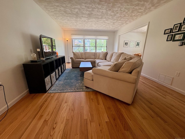 64 Sherwood Ln, Norwich, CT 06360 - living area with baseboards, light wood-style flooring, visible vents, and a textured ceiling