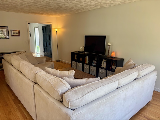 64 Sherwood Ln, Norwich, CT 06360 - living room with baseboards, a textured ceiling, and wood finished floors