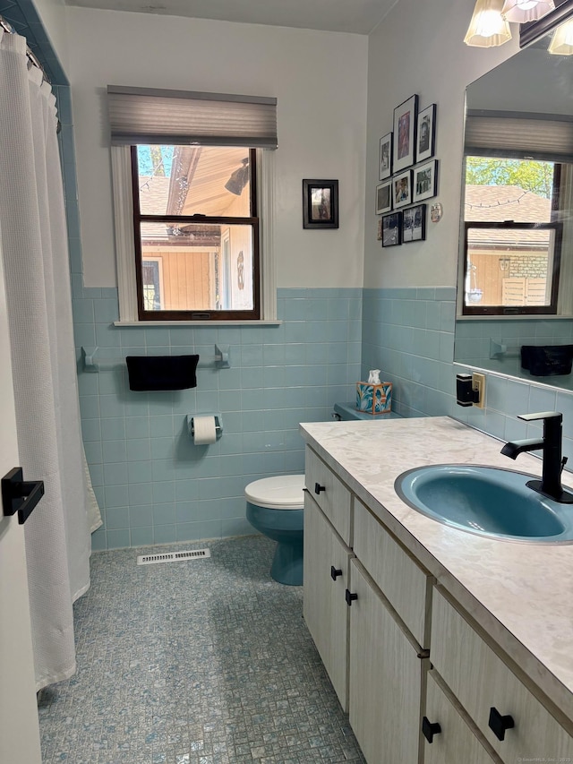 64 Sherwood Ln, Norwich, CT 06360 - full bathroom with tile walls, vanity, visible vents, and plenty of natural light