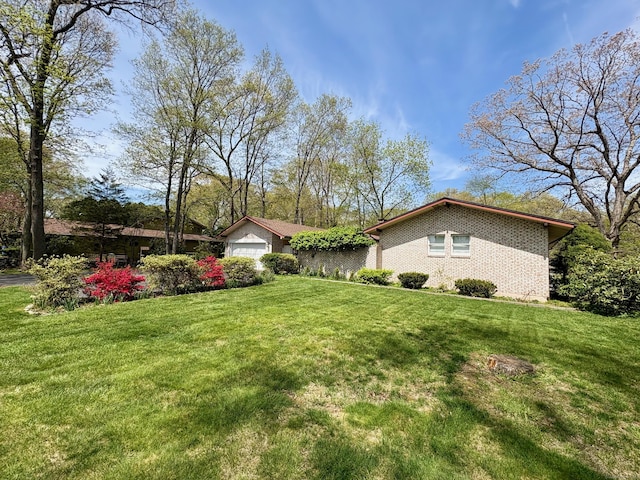 64 Sherwood Ln, Norwich, CT 06360 - exterior space featuring a front lawn, brick siding, and a garage