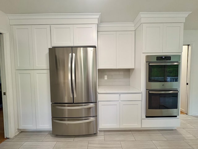 64 Sherwood Ln, Norwich, CT 06360 - kitchen with stainless steel appliances, decorative backsplash, light stone counters, and white cabinets