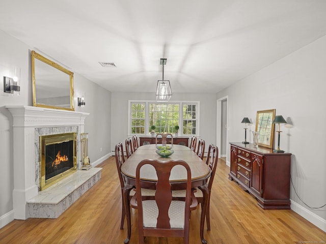 44 Buckingham Ridge Rd, Wilton, CT 06897 - dining area with light wood finished floors, a high end fireplace, and baseboards