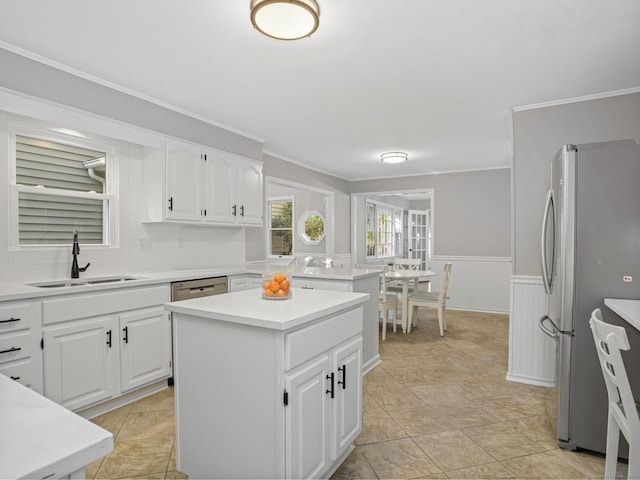 44 Buckingham Ridge Rd, Wilton, CT 06897 - kitchen with a sink, freestanding refrigerator, a kitchen island, wainscoting, and light countertops
