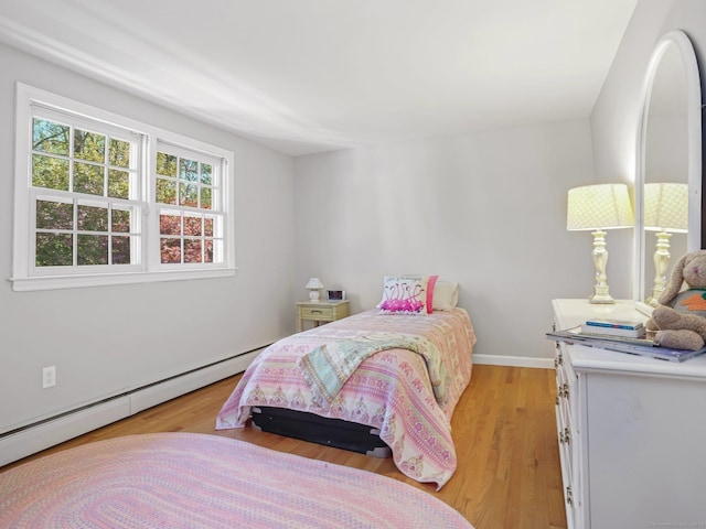 44 Buckingham Ridge Rd, Wilton, CT 06897 - bedroom with a baseboard heating unit and light wood-style flooring