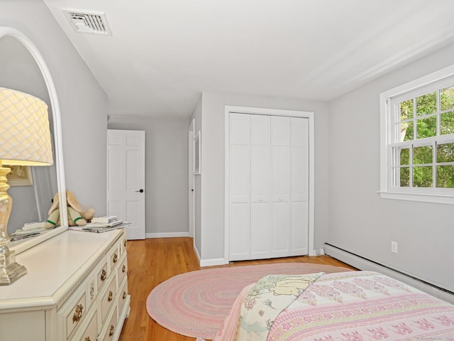 44 Buckingham Ridge Rd, Wilton, CT 06897 - bedroom with a baseboard radiator, a closet, and light wood-style floors