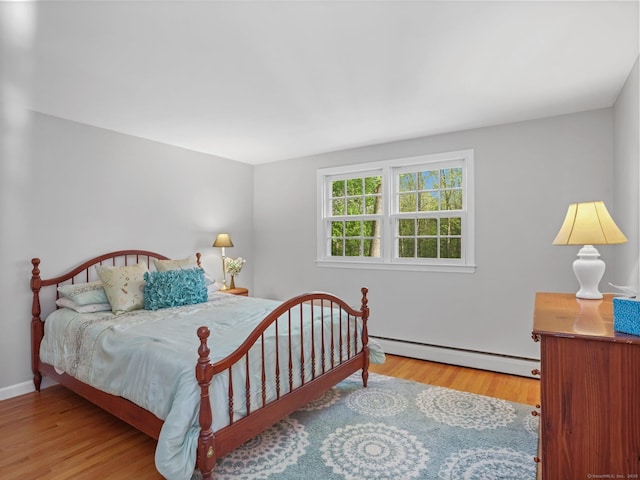 44 Buckingham Ridge Rd, Wilton, CT 06897 - bedroom with a baseboard heating unit, wood finished floors, and baseboards