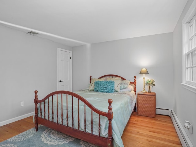 44 Buckingham Ridge Rd, Wilton, CT 06897 - bedroom with a baseboard heating unit, wood finished floors, and baseboards