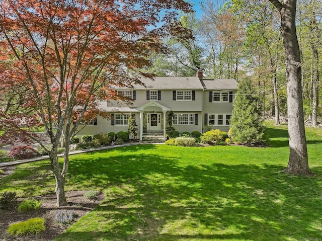 44 Buckingham Ridge Rd, Wilton, CT 06897 - view of front of home featuring a chimney and a front yard