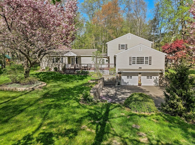44 Buckingham Ridge Rd, Wilton, CT 06897 - view of green lawn with a deck, an attached garage, and driveway