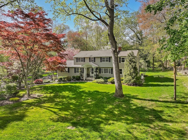 44 Buckingham Ridge Rd, Wilton, CT 06897 - view of front of home with a front yard and a chimney