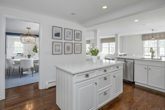 kitchen featuring a sink, decorative columns, dishwasher, baseboard heating, and a kitchen island