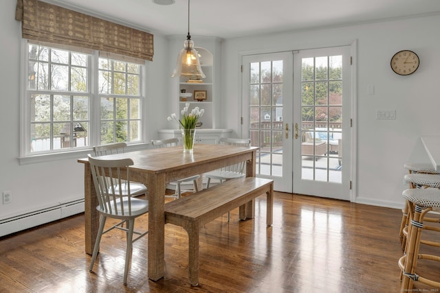 dining room with baseboards, french doors, and wood finished floors
