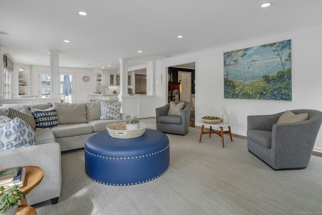 living area featuring ornate columns and recessed lighting