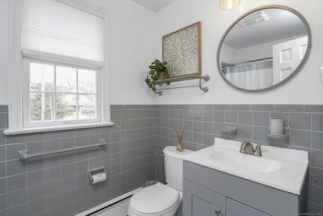 full bathroom with toilet, a wainscoted wall, tile walls, visible vents, and vanity