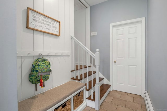 staircase featuring tile patterned flooring and baseboard heating