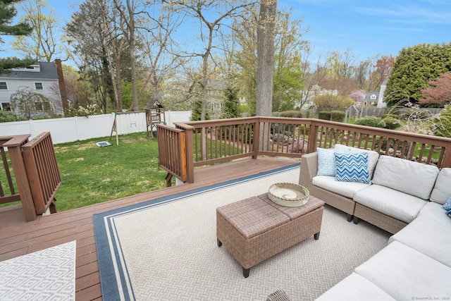 wooden deck with a fenced backyard, outdoor lounge area, and a lawn