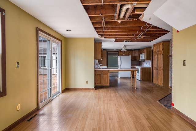 kitchen with baseboards, visible vents, white appliances, and plenty of natural light