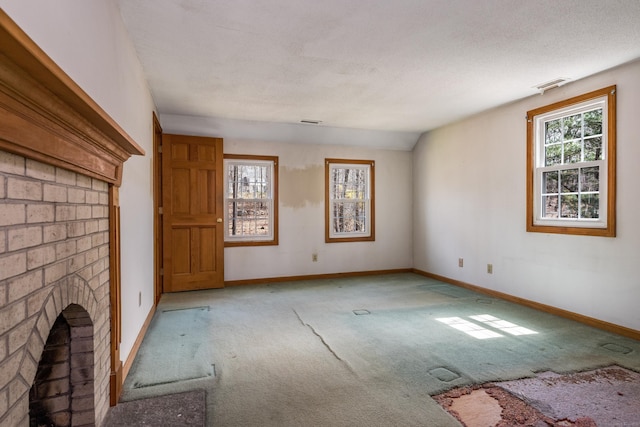 unfurnished living room with carpet floors, visible vents, and baseboards