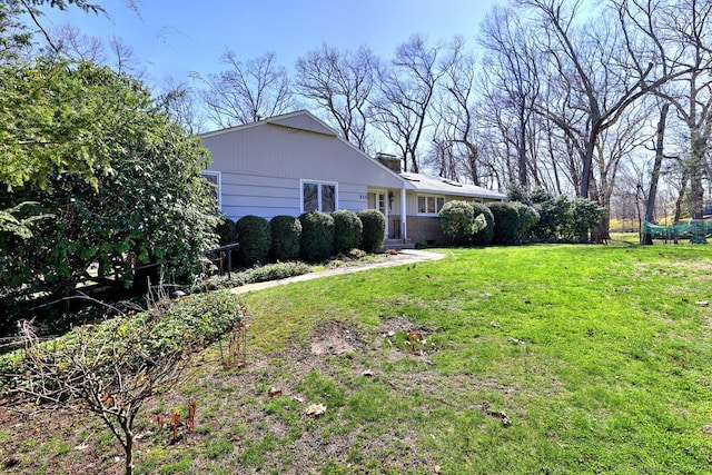 view of front of property featuring a front yard and a chimney