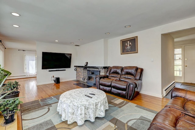 living room with wood finished floors, recessed lighting, baseboards, and a baseboard radiator