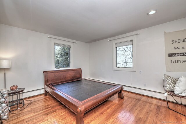 bedroom with wood finished floors and recessed lighting