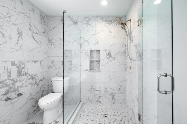 full bathroom with a stall shower, tile walls, recessed lighting, and toilet