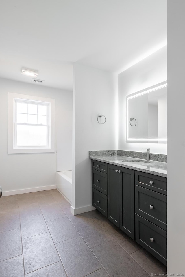 full bathroom with a bathtub, visible vents, baseboards, tile patterned flooring, and vanity