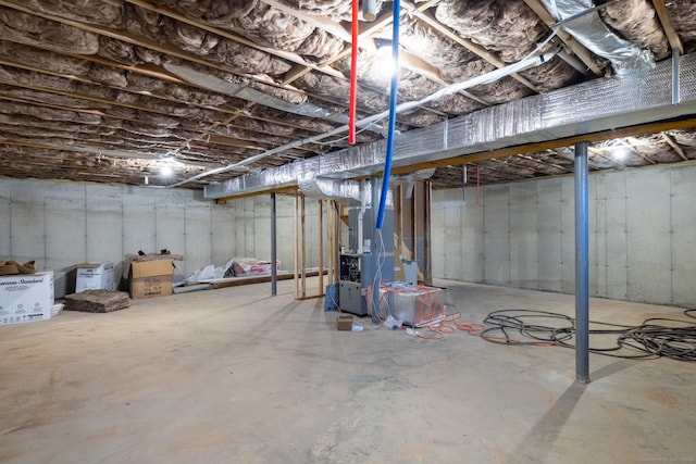 unfinished basement featuring heating unit