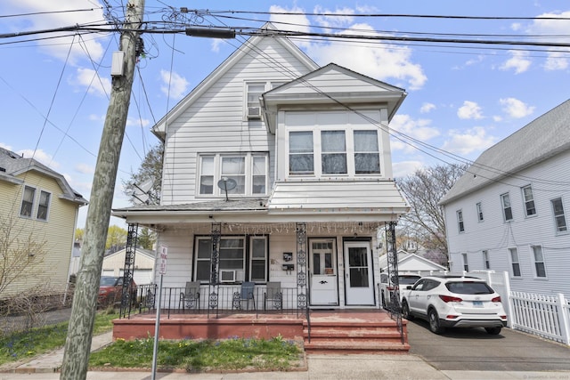 view of front of property with fence and covered porch