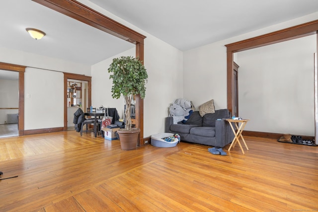 sitting room featuring radiator and light wood-type flooring
