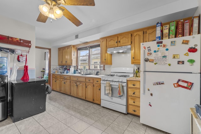 kitchen with white appliances, light countertops, a ceiling fan, under cabinet range hood, and visible vents