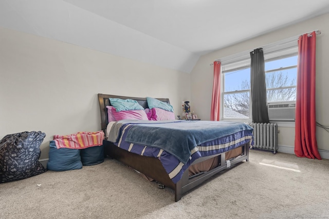 bedroom featuring radiator heating unit, vaulted ceiling, carpet flooring, and cooling unit
